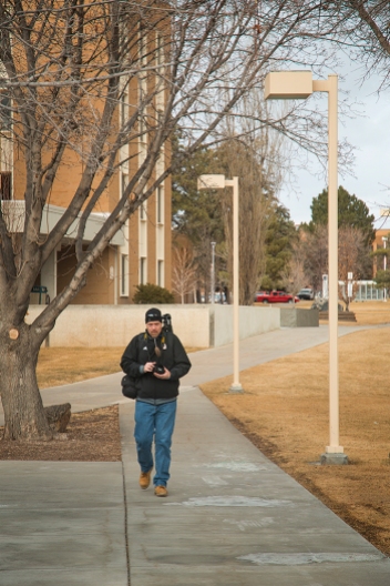 Photo media student, Ed Ritterbush, walks across campus while on assignment, Thursday, Jan. 30, 2014, in Pocatello, Idaho. Ritterbush engaged strangers on the street as part a journalistic exercise at Idaho State University. (ISU Photo/Terry Ownby)
