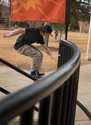 Skateboarder Ian Brown, 19, aciddrops off the stairs near the entrance to the Pond Student Union Building, Thursday, Jan. 30, 2014, in Pocatello, Idaho. Brown stated he recently moved from Arco, Idaho to live near the ISU campus. (ISU Photo/Terry Ownby)